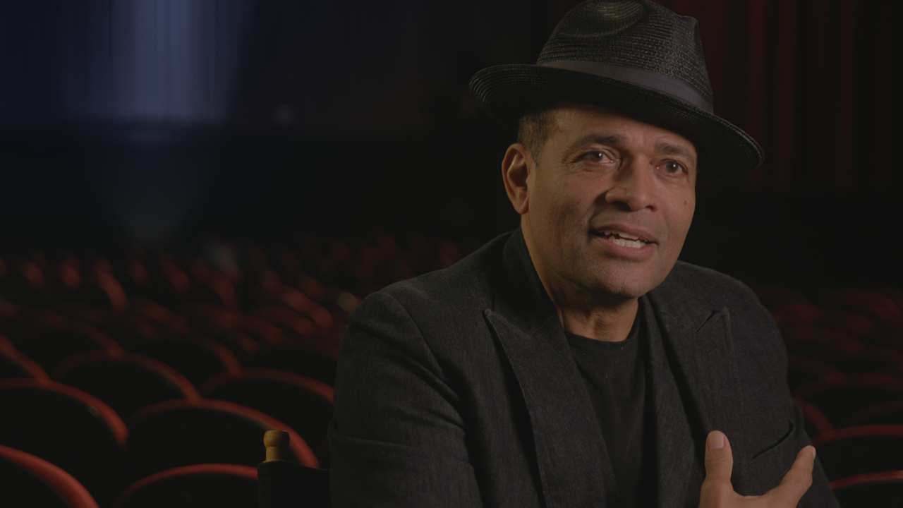 a man with a hat and a blazer